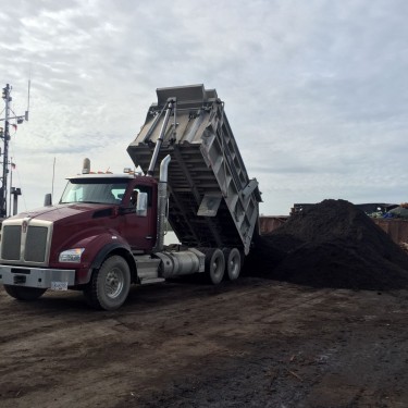 Soil being loaded onto a barge, headed for Haida Gwaii